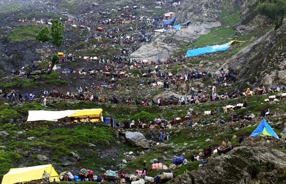 Hindu pilgrims travelling either on ponies or on foot, to holy cave of Lord Shiva during an annual pilgrimage, in Pishutop
